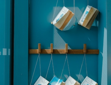 six hanging books on wall
