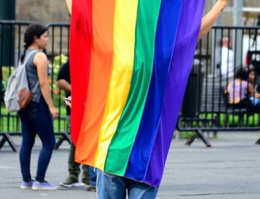 person holding multicolored flag